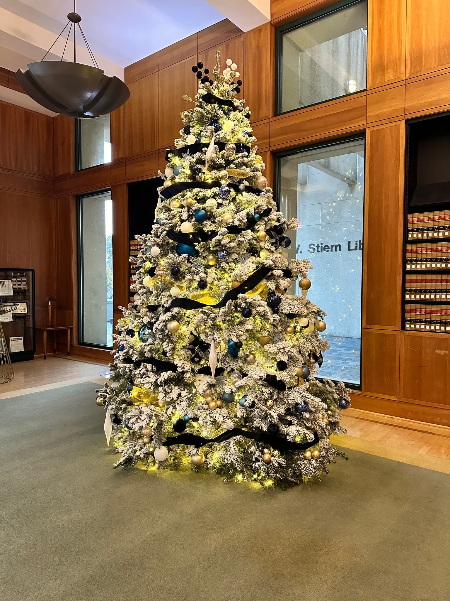 Flocked Tree Decorated for a Commercial Lobby. Christmas light installation by Bright Idea Christmas Lights.