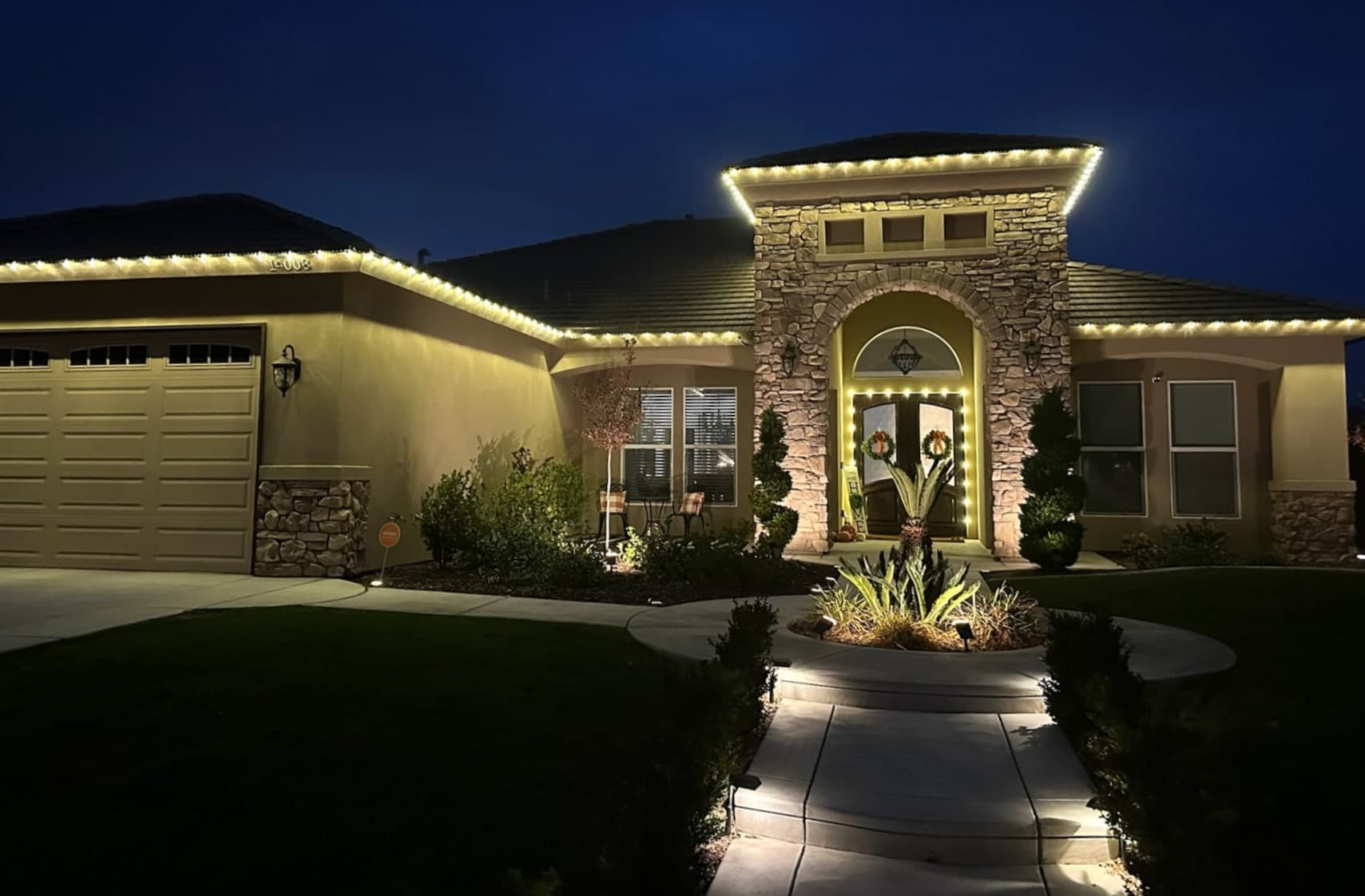 Warm White Roofline with Door Trim. Christmas light installation by Bright Idea Christmas Lights.